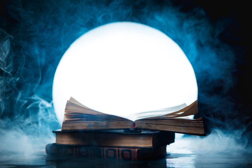 An open book of spells in full Moon. Reader imagination and writing inspiration concept with copy